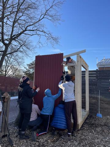 Volunteers building a garden shed